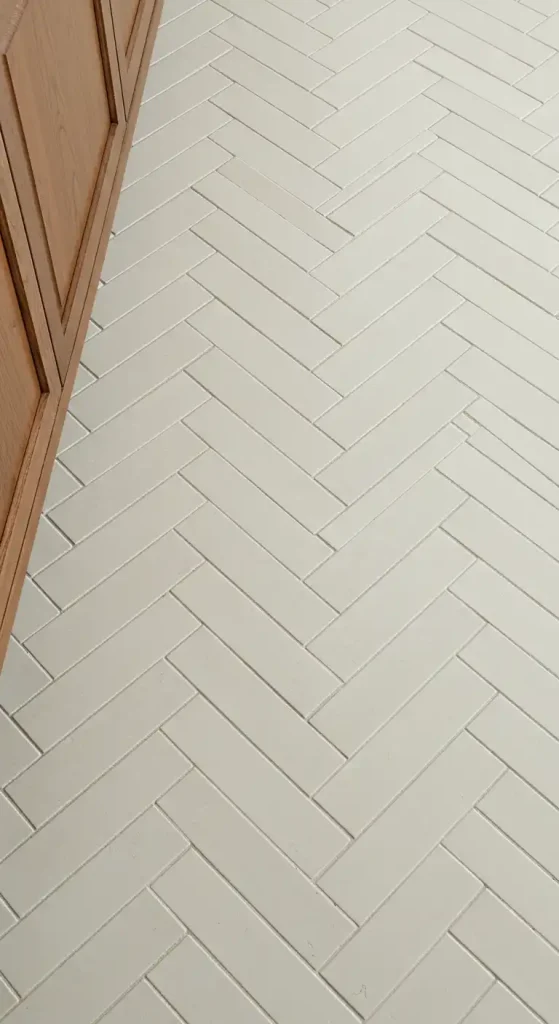10 Timeless Kitchen Ceramic Tile Flooring Ideas for a Classic Look 19 Herringbone Pattern in Creamy Whites